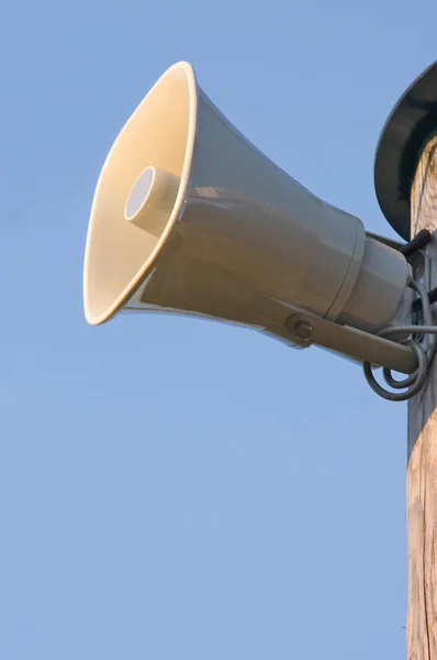 Grey horn loudspeaker on the pole over blue sky — Stock Photo, Image