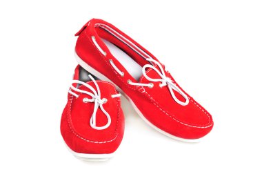 Pair of red moccasins isolated over white clipart