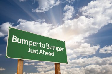 Bumper to Bumper Green Road Sign and Clouds clipart