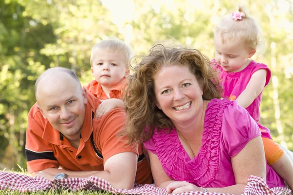 Gelukkige jonge familie met twins portret in park — Stockfoto