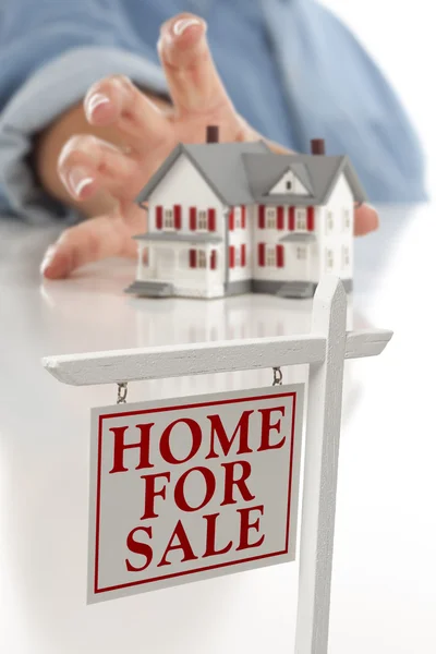 Real Estate Sign in Front of Woman Reaching for House — Stock Photo, Image