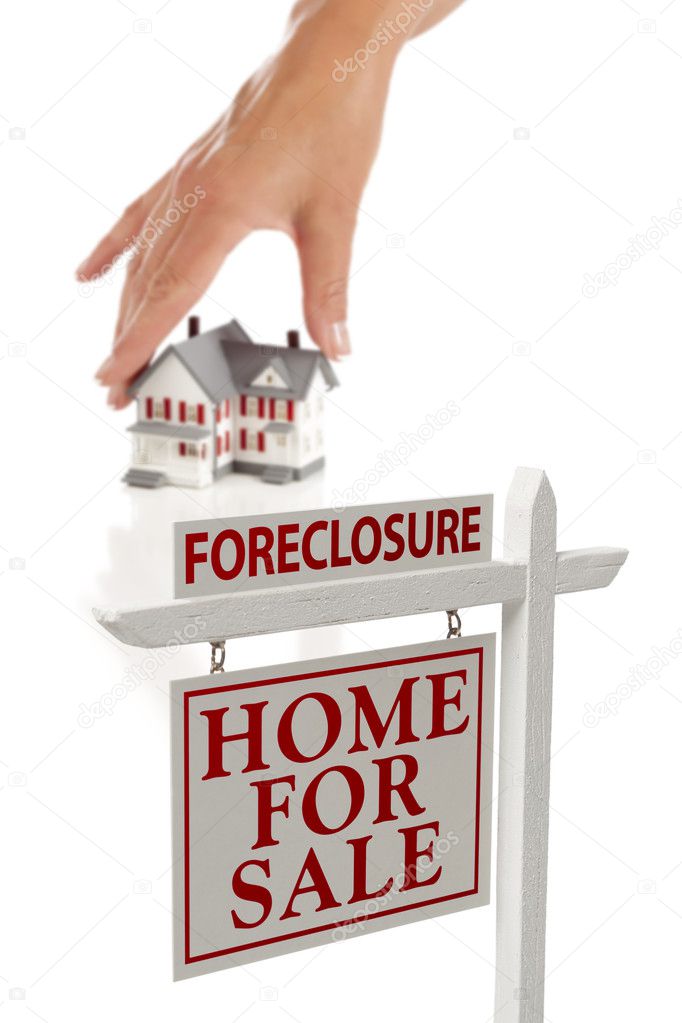 Womans Hand Choosing Home with Foreclosure Real Estate Sign