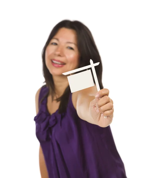Багатонаціональна жінка тримає в руках маленький порожній знак нерухомості — стокове фото