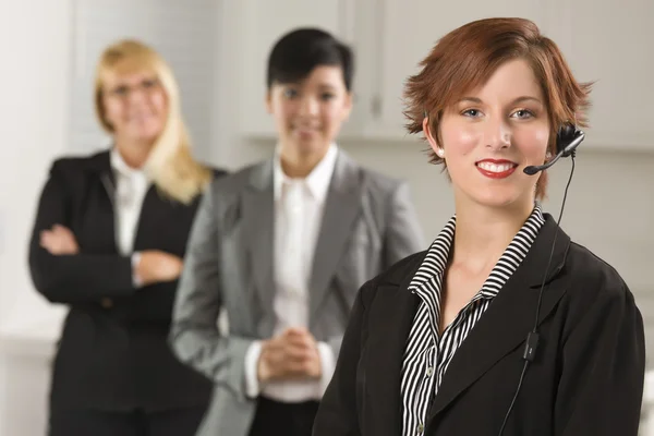 Pretty Red Haired Businesswoman with Headset and Colleagues — Stock Photo, Image