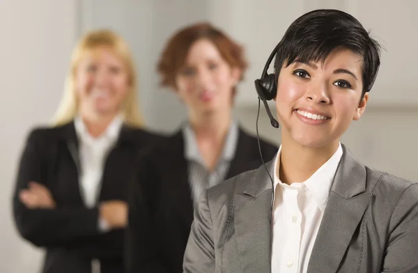 Pretty Hispanic Businesswoman with Colleagues Behind — Stock Photo, Image