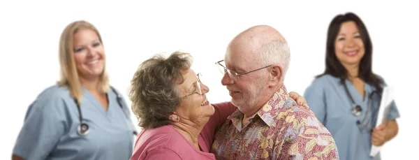 Senior Couple with Medical Doctors or Nurses Behind — Stock Photo, Image