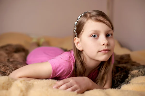 Portræt af en lille pige i sengen - Stock-foto