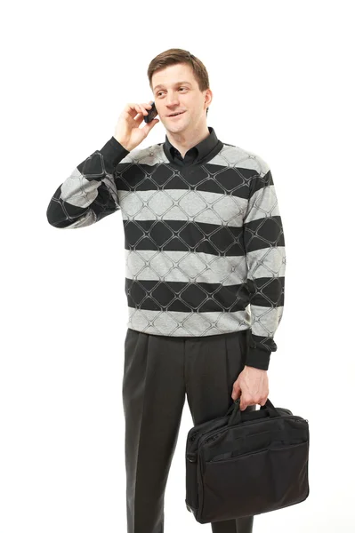Aantrekkelijke jonge man in de trui met geval en telefoon — Stockfoto