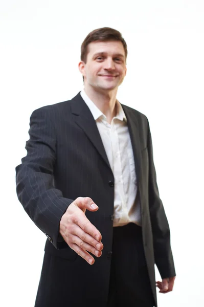 Attractive young man giving hand for handshake, focus on hand — Stock Photo, Image