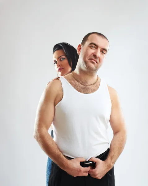Portrait of a gangster in white tank top with his woman — Stock Photo, Image