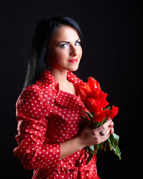 Young woman with red flowers — Stock Photo, Image