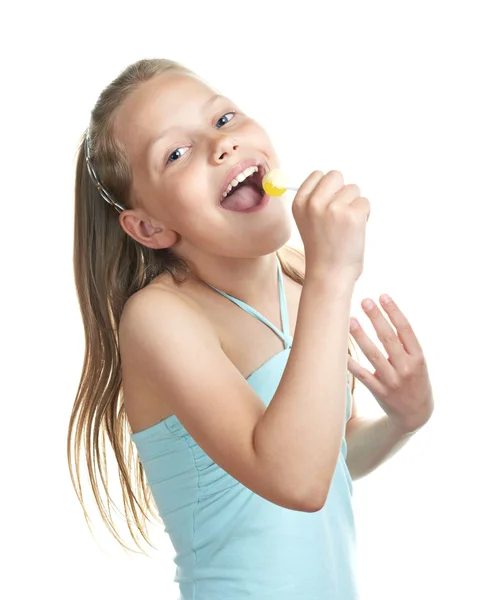 Cheerful little girl with lollipop singing — Stock Photo, Image
