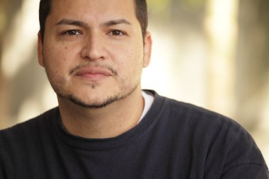 Headshot of a young Latino man clipart