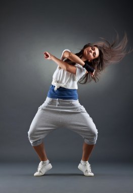 Female dancing on the grey background clipart