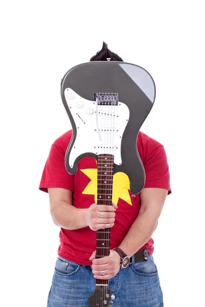 Гитарист держит гитару над лицом — стоковое фото