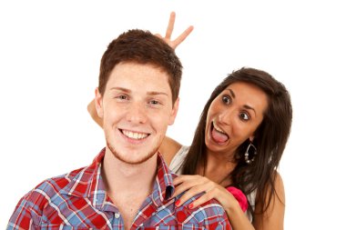 Woman goofing around behind her boyfriend clipart