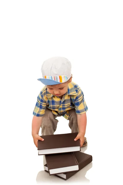 Boy arranging some brown books — Stock Photo, Image