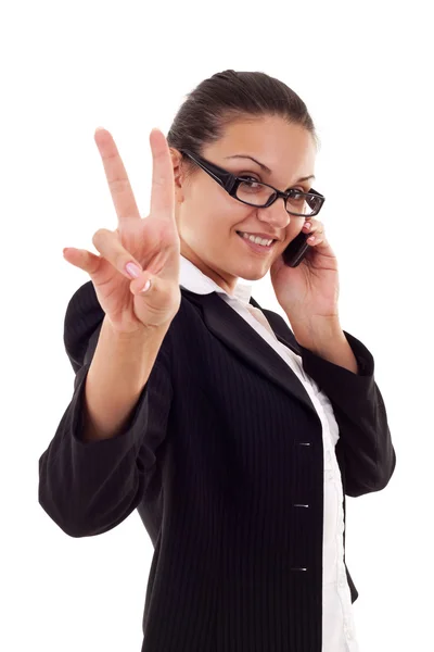 Mujer de negocios con teléfono y gesto de victoria —  Fotos de Stock