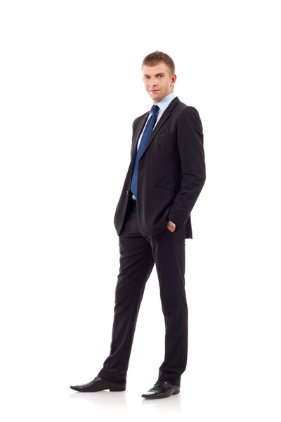 Full length of a handsome business man standing with hands in pocket against white