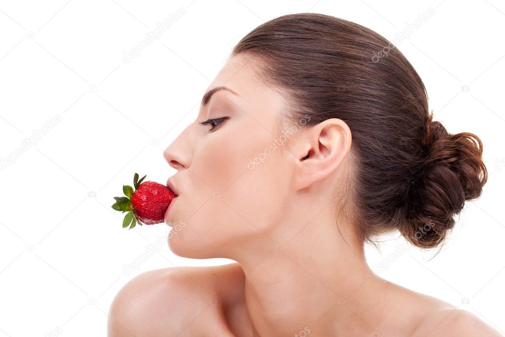 Sexy woman with strawberry in mouth