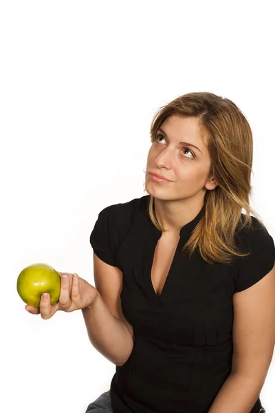 Young woman holding green fruit over white background — Stock Photo, Image
