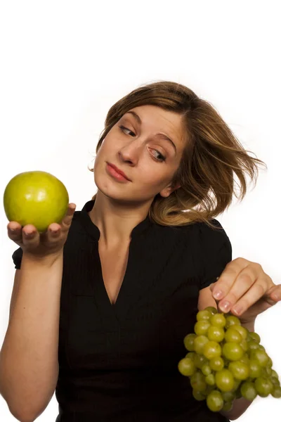 Young woman holding green fruit over white background — Stock Photo, Image