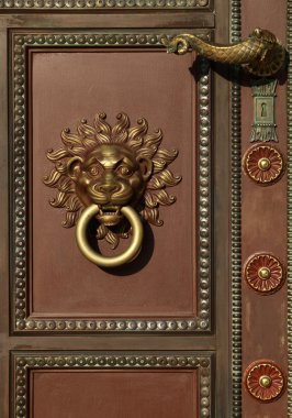 Door handle and door knocker with lion head clipart