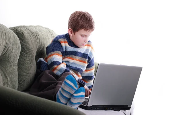 Young child with laptop on couch at home — Stock Photo, Image