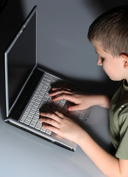 Young child with laptop on couch at home — Stock Photo, Image