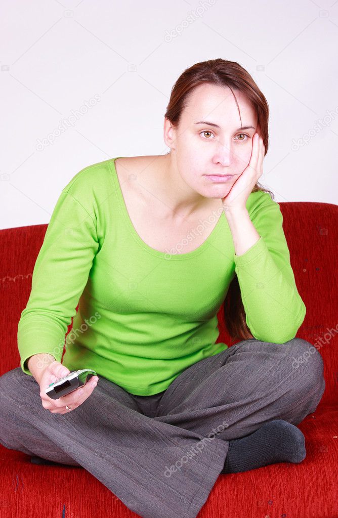 Young women watching TV with remote control