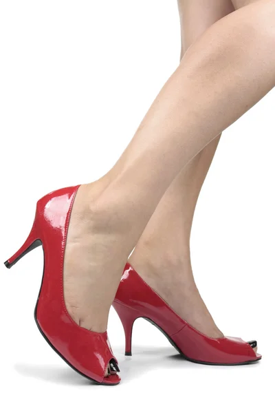 Pernas de mulher vestindo sapatos de salto vermelho — Fotografia de Stock