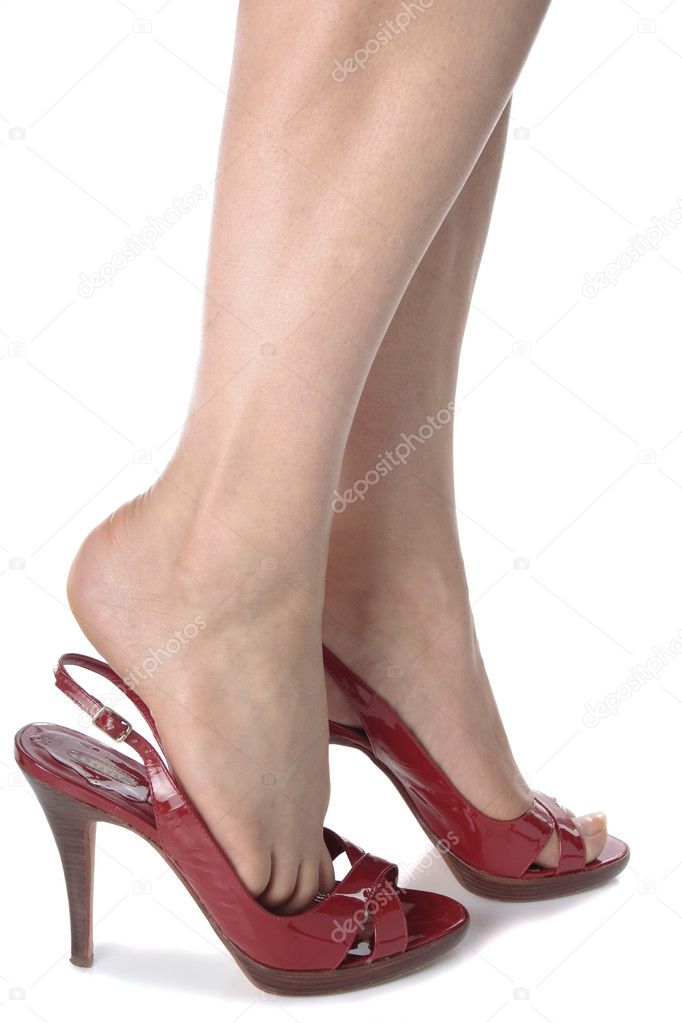Woman legs wearing red heel shoes isolated over white background