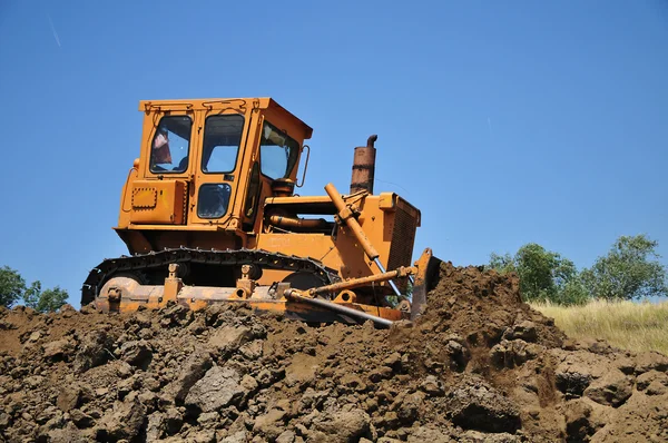 Gul grävmaskin på byggarbetsplats — Stockfoto
