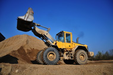 Yellow Excavator at Construction Site clipart