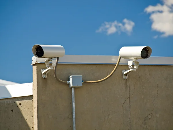 Камеры безопасности, осуществляющие наблюдение на стороне здания — стоковое фото