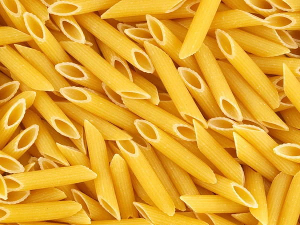 Closeup Background of Uncooked Italian Penne Pasta — Stock Photo, Image