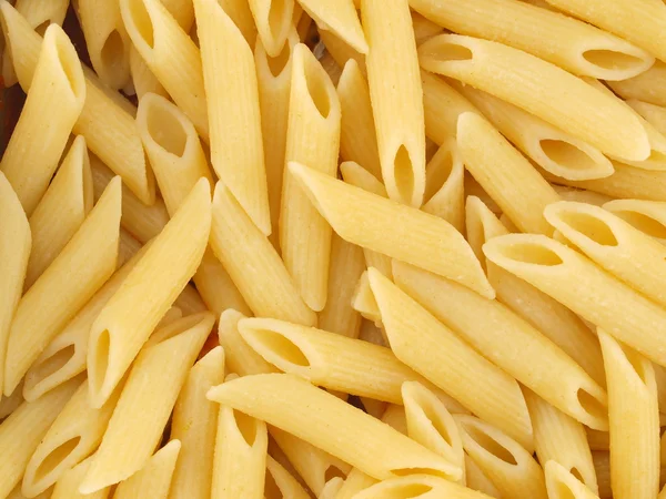 Närbild bakgrund av kokta italiensk penne pasta — Stockfoto