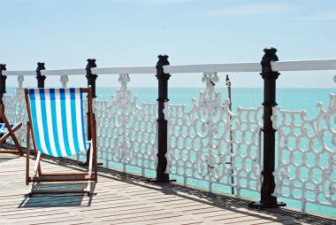 Beach chair on the pier clipart