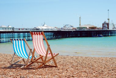 Deck chairs on the beach Brighton England clipart