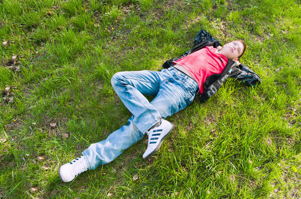 Boy Lying On The Fresh Green Grass