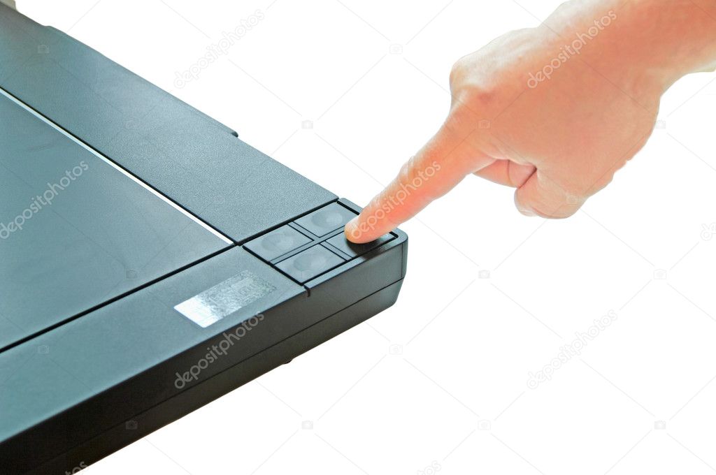 The hand presses the scan button