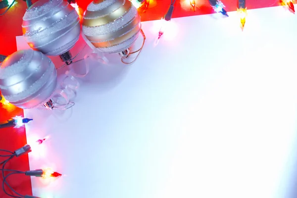 New Christmas baubles border with holiday lights. — Stock Photo, Image