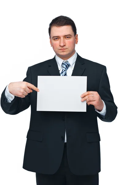 Homme d'affaires tenant et pointant vers un panneau d'affichage vide — Photo