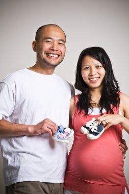 Happy expecting asian couple clipart