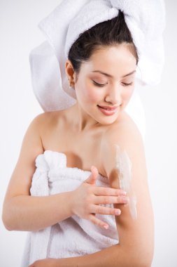 Beautiful asian spa woman and lotion clipart