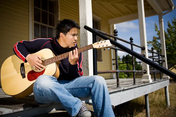 Asian playing guitar — Stock Photo, Image