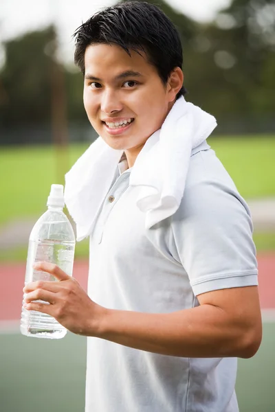 Asiático masculino segurando garrafa de água — Fotografia de Stock