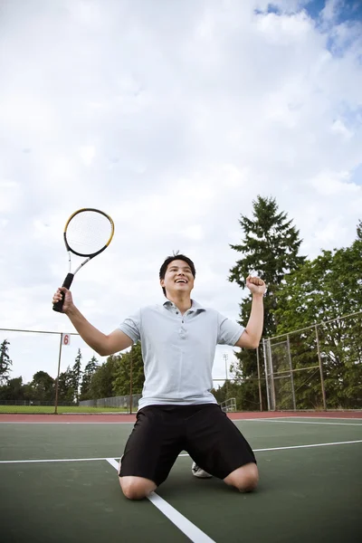 Joueur de tennis asiatique dans la joie après avoir gagné — Photo