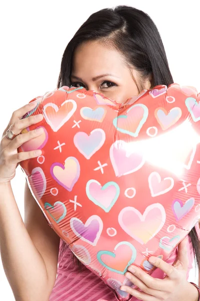Asian woman hugging heart-shaped balloon — Stock Photo, Image