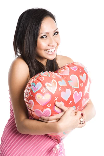 Asian woman hugging heart-shaped balloon — Stock Photo, Image
